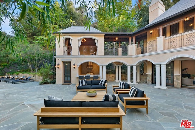 view of patio featuring outdoor lounge area and a balcony