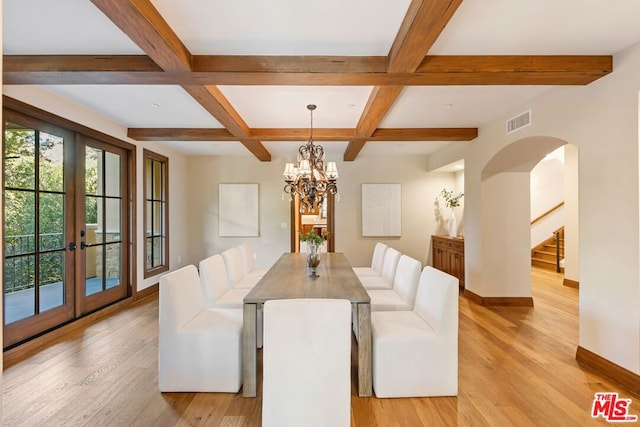 dining space with french doors, coffered ceiling, light hardwood / wood-style flooring, beamed ceiling, and a notable chandelier