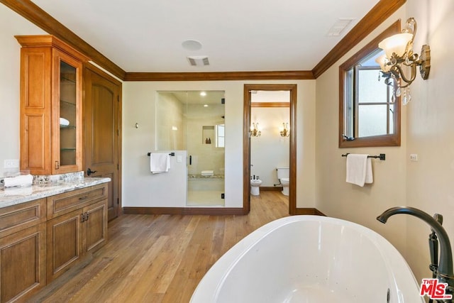 bathroom with a bath, a bidet, wood-type flooring, vanity, and ornamental molding