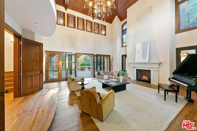 living room with french doors, high vaulted ceiling, and a healthy amount of sunlight