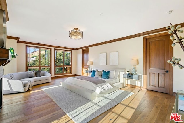 bedroom featuring crown molding and light hardwood / wood-style floors