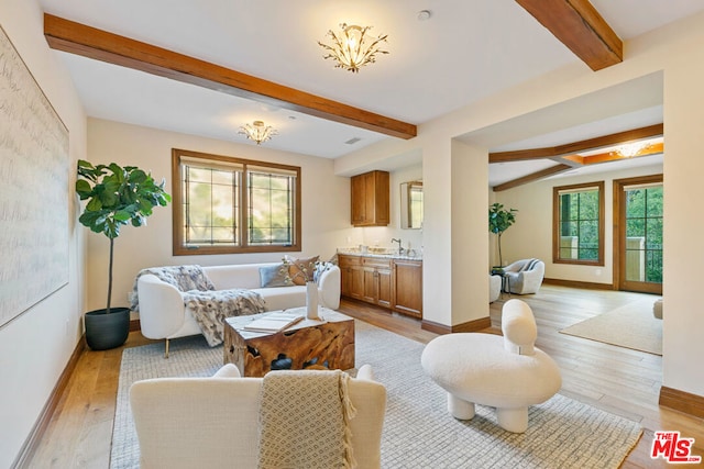 living room featuring light hardwood / wood-style flooring and beamed ceiling