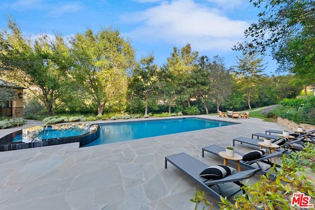 view of pool featuring a patio area