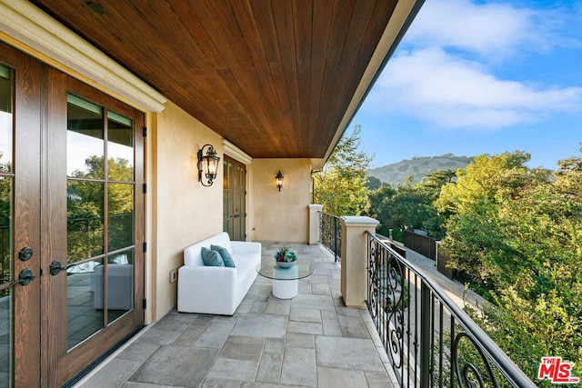 balcony featuring a mountain view and french doors