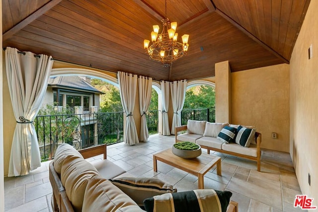 sunroom / solarium featuring a chandelier, lofted ceiling with beams, and wood ceiling