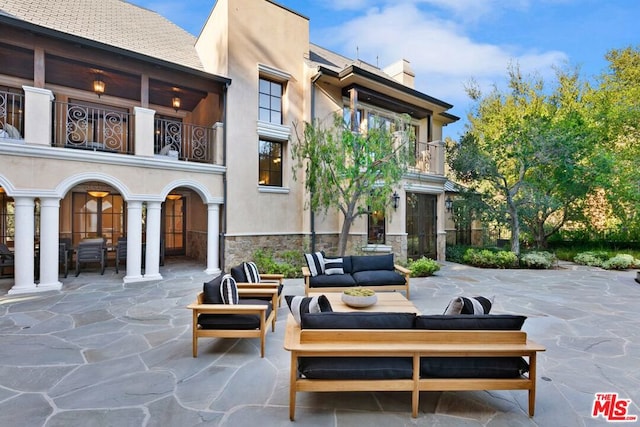 view of patio featuring a balcony and an outdoor hangout area