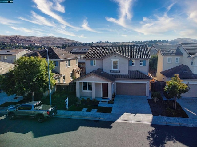 view of front facade with a mountain view and a garage