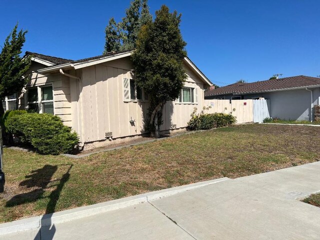 view of home's exterior with a lawn