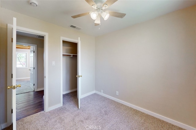 unfurnished bedroom featuring ceiling fan, a closet, and carpet