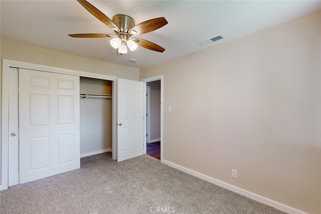 unfurnished bedroom with ceiling fan, a closet, and carpet