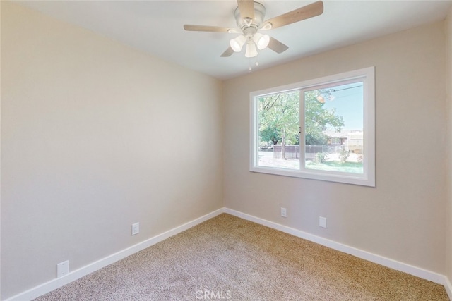 spare room with carpet flooring and ceiling fan