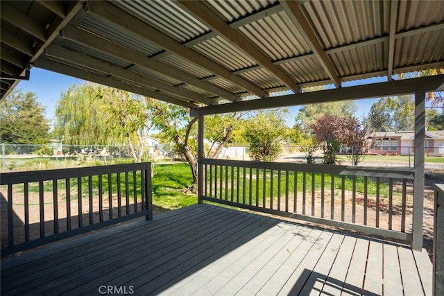 wooden deck featuring a lawn