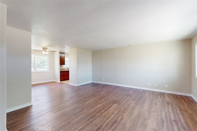 interior space featuring ceiling fan and dark hardwood / wood-style flooring