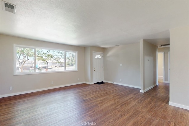 interior space featuring dark hardwood / wood-style floors and a textured ceiling