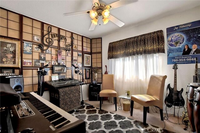 sitting room with carpet flooring and ceiling fan