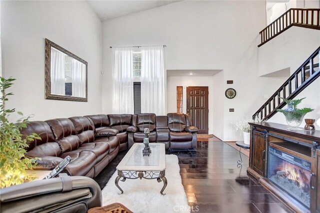 living room featuring dark hardwood / wood-style floors and high vaulted ceiling