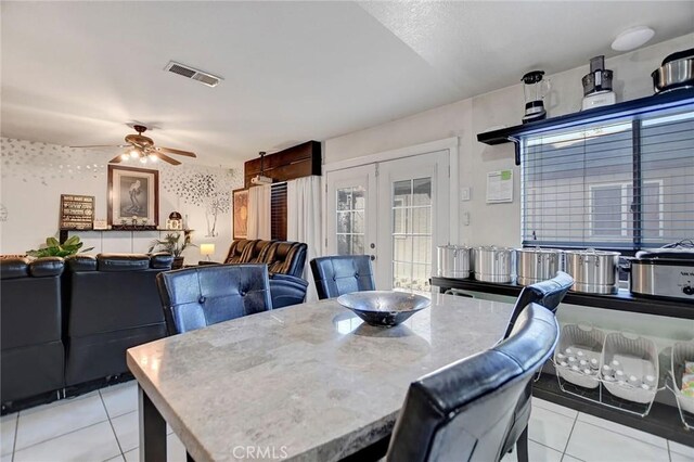 tiled dining space with french doors and ceiling fan