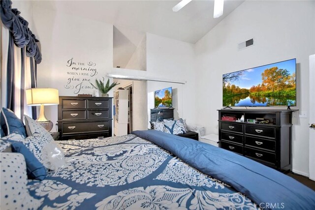 bedroom with ceiling fan and high vaulted ceiling