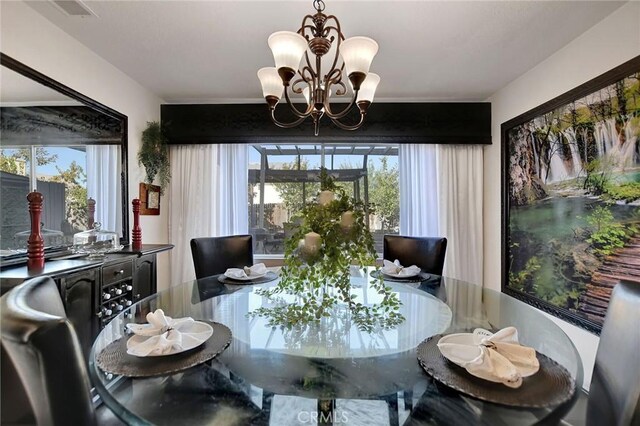 dining space with a wealth of natural light and a chandelier