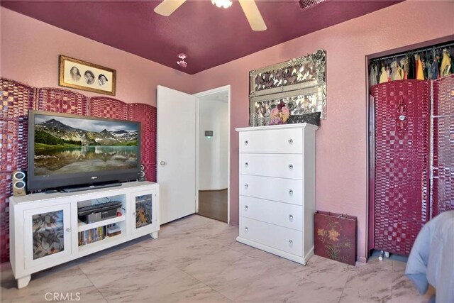 interior space featuring ceiling fan, a closet, and lofted ceiling