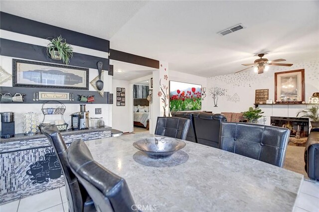 dining area featuring ceiling fan and light tile patterned floors