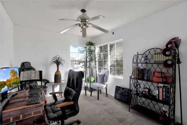 office space with light carpet and ceiling fan