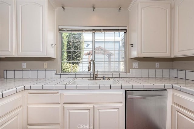 kitchen featuring dishwasher, white cabinets, and sink