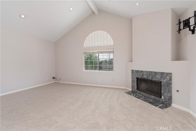 unfurnished living room featuring beamed ceiling, light colored carpet, a fireplace, and high vaulted ceiling