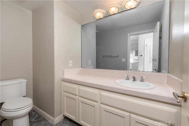 bathroom featuring vanity and toilet