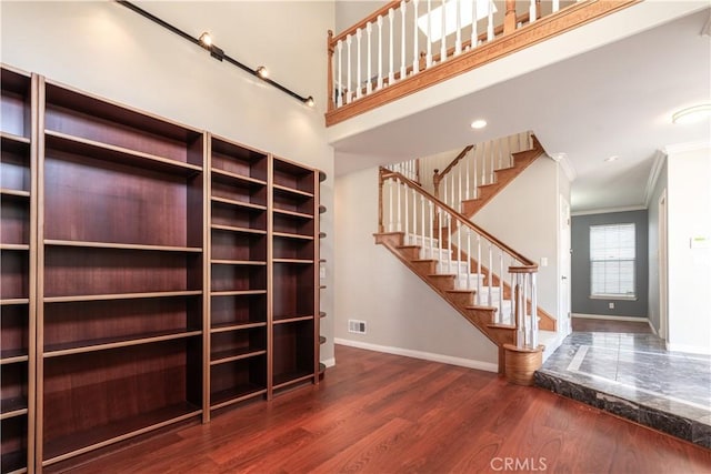 unfurnished living room with crown molding and dark hardwood / wood-style floors