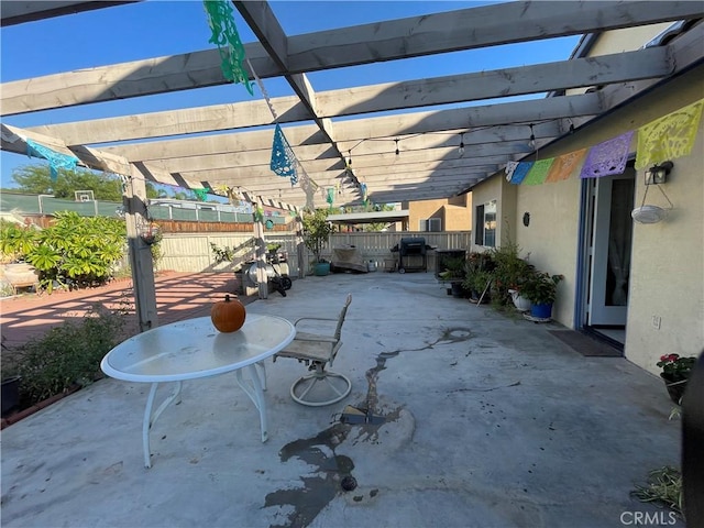 view of patio with a grill and a pergola