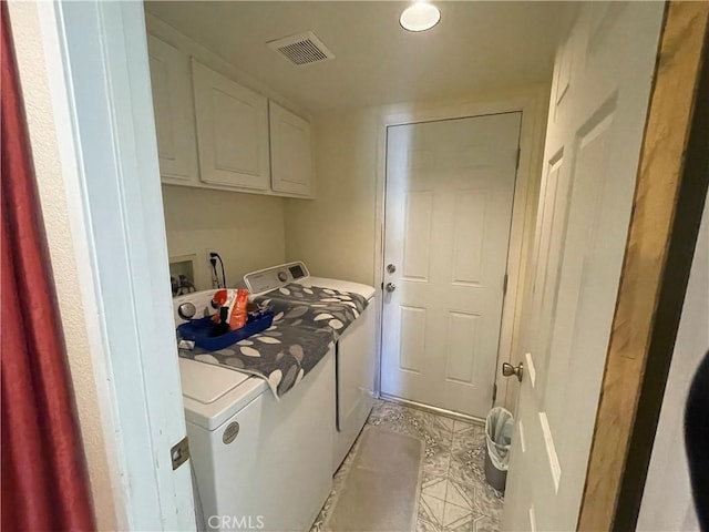 laundry area with cabinets, light tile patterned floors, and separate washer and dryer