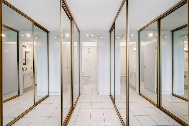 bathroom featuring tile patterned flooring, toilet, and sink