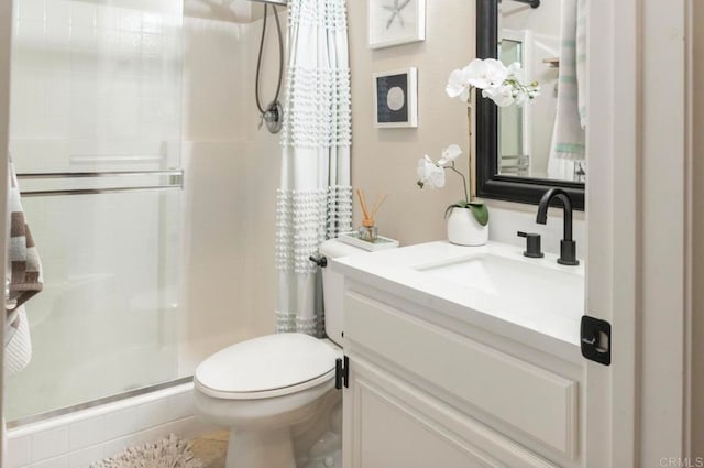 bathroom with a shower with shower curtain, vanity, and toilet