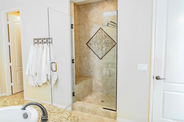 bathroom featuring tile patterned flooring and separate shower and tub