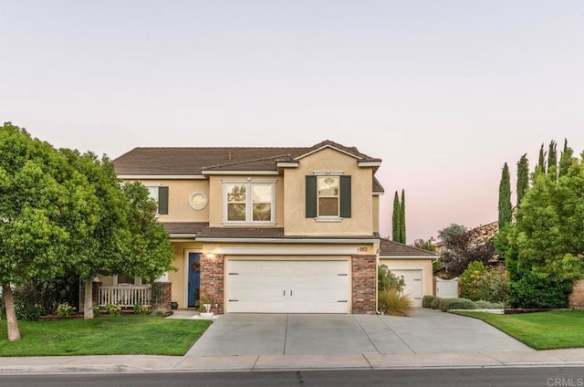 front facade with a lawn and a garage