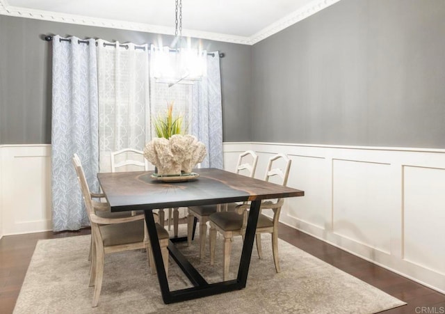 dining room featuring dark wood-type flooring and crown molding