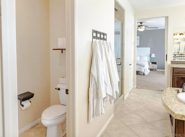 bathroom with tile patterned flooring, vanity, toilet, and ceiling fan