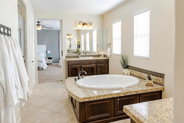 bathroom featuring ceiling fan, vanity, a tub to relax in, and tile patterned flooring