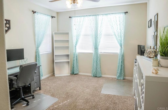 office space featuring light carpet and ceiling fan