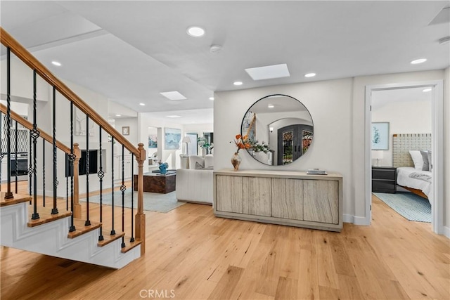 interior space with a skylight and light wood-type flooring