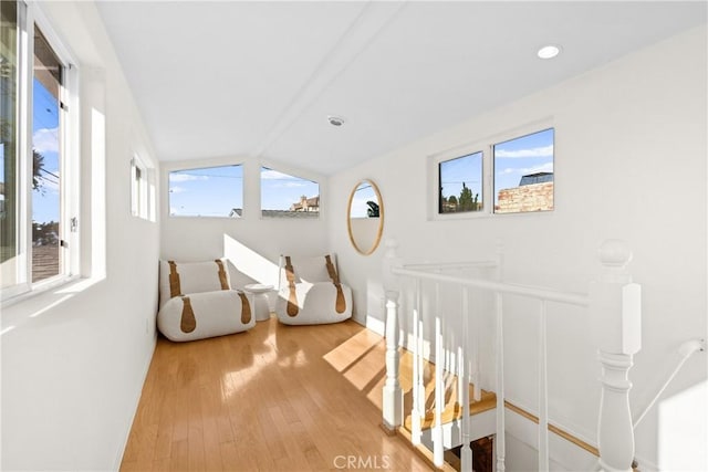 interior space featuring hardwood / wood-style flooring and vaulted ceiling