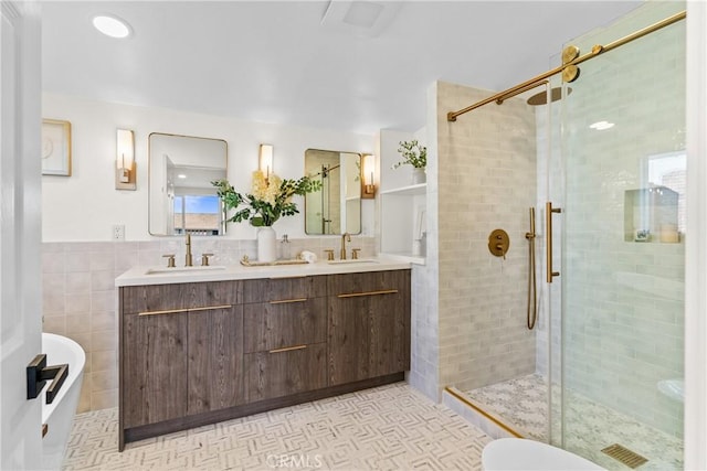 bathroom with vanity, tile walls, an enclosed shower, and tile patterned floors