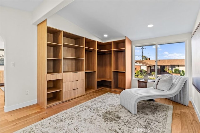 living area with lofted ceiling and light wood-type flooring