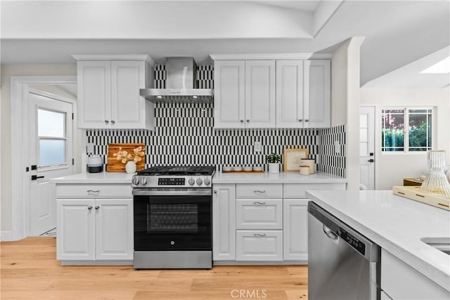 kitchen featuring white cabinetry, a healthy amount of sunlight, and stainless steel appliances