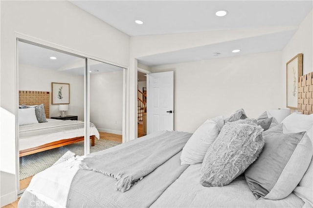 bedroom featuring hardwood / wood-style floors and a closet