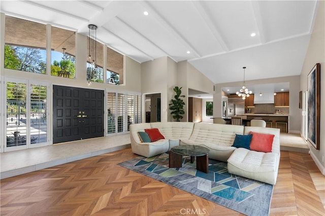 living area with baseboards, beam ceiling, recessed lighting, an inviting chandelier, and high vaulted ceiling