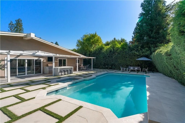 pool with outdoor dry bar and a patio area