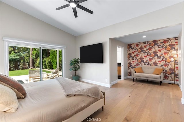 bedroom featuring light wood-type flooring, a ceiling fan, baseboards, access to exterior, and vaulted ceiling