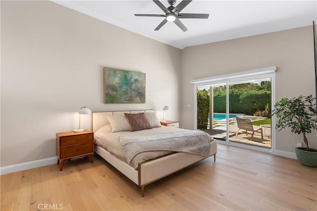 bedroom featuring baseboards, light wood-style flooring, and access to outside